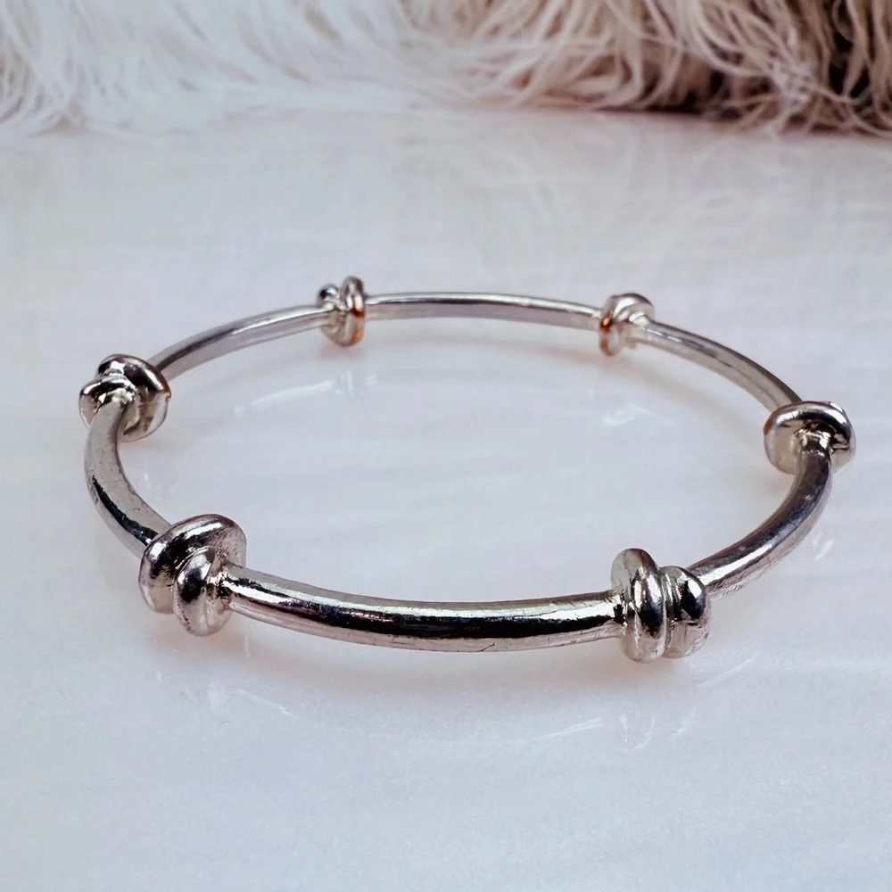 Pretty Silvertone weighted knotted bangle stacking bracelet